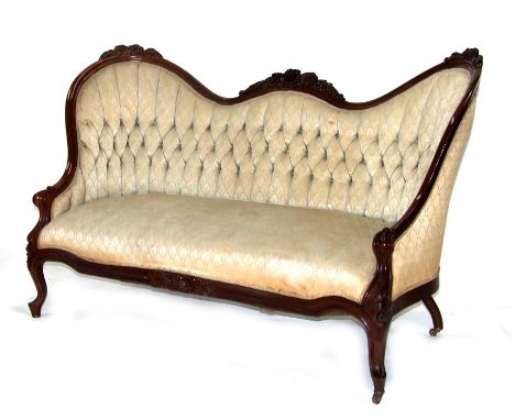 A Victorian walnut show wood camel back sofa with upholstered seat and buttoned back, 155cms (61ins) wide.