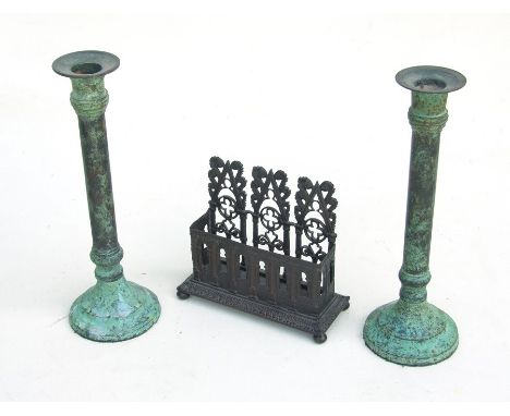 A Gothic Revival bronzed spelter letter rack, 14cms wide; together with a pair of candlestick with verdigris decoration, 23cm