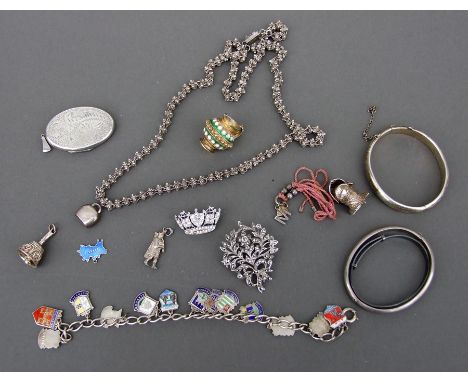 A quantity of silver and white metal jewellery to include a charm bracelet with enamel charms.