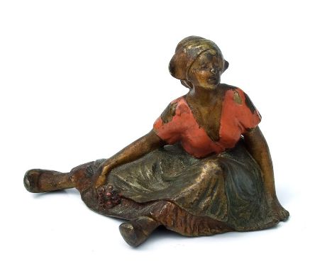 An early 20th century cold painted bronze risqué figure of a young Dutch girl, 6cms high.