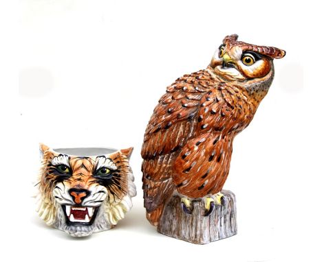 An Italian pottery figure of a long eared owl seated on a tree stump, 50cms high; together with a tigers head ceramic planter