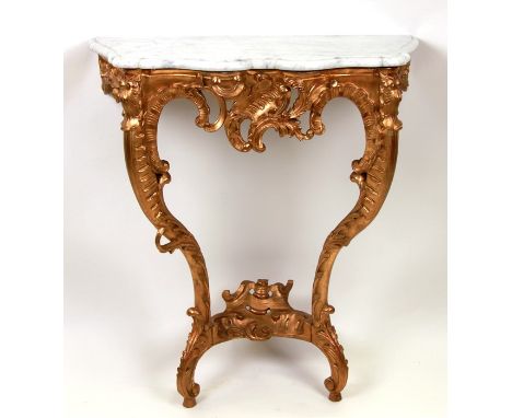 A late 19th / early 20th century French giltwood serpentine console table of rococo revival style, the shaped marble top abov