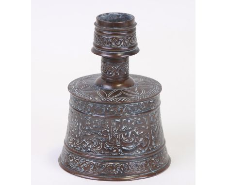 A Persian / Islamic bronze candlestick decorated with script around the body. 10cm highCondition Reportbase 8cm diameter, 11c