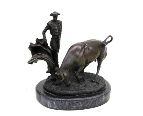 A large modern bronze group depicting a bull and matador, on a marble base, 24.5 cms (9.5 ins) high.
