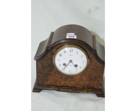 A Polished Walnut Encased Mantel Clock With Circular Dial Retailed By Russells Ltd, Liverpool