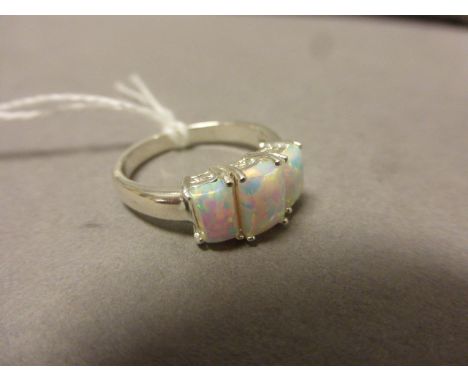 A silver and opal three stone ring