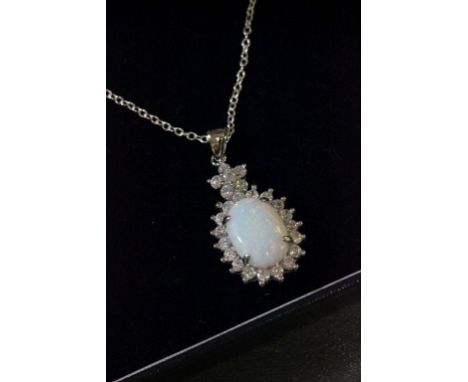 A silver and opal daisy style pendant necklace on a silver chain