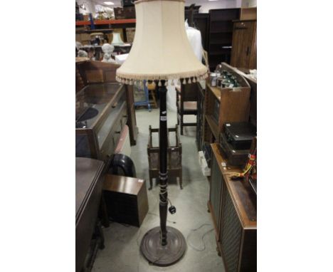 A mid 20th century mahoganty standard lamp and shade 