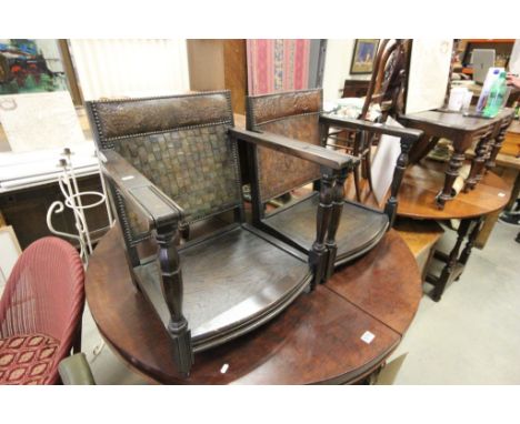 A matched pair of vintage Ercol leather lattice  backed  fireside armchairs lacking cushions.