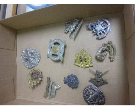 Collection of eleven vintage cap badges to include Canadian