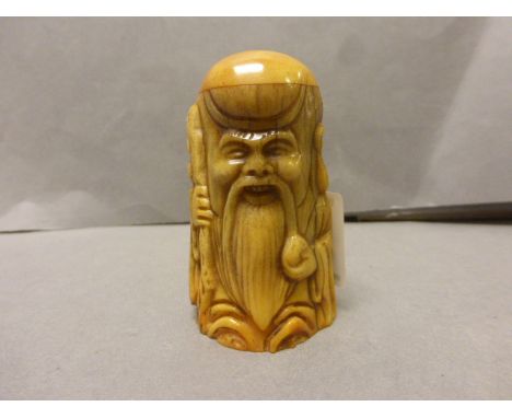 Bone netsuke of a man with stake