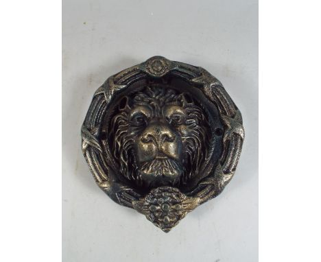 A Cast Metal Lion Head Door Knocker (Plus VAT).