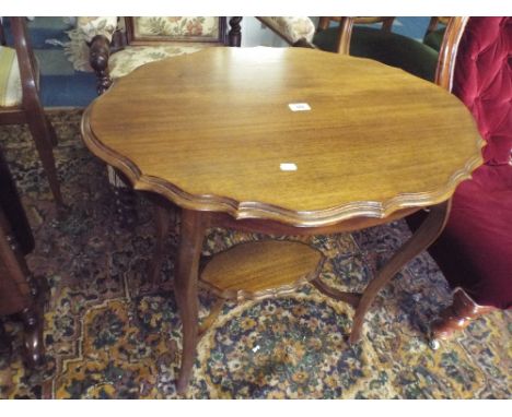 A Serpentine Topped Mahogany Occasional Table with Stretcher Shelf.