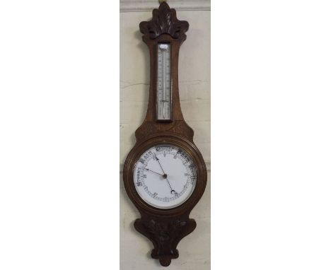 A Late Victorian Oak Aneroid Wheel Barometer with Temperature Scale. 