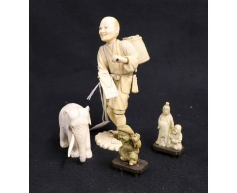 Japanese sectional ivory model of a farmer carrying a basket on his back, a carved ivory elephant and a composition model of 