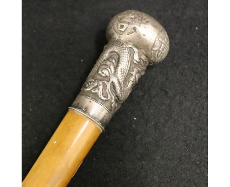 Chinese malacca cane, the silver pommel decorated in relief with a dragon and good luck characters, marked 95, KW (possibly E