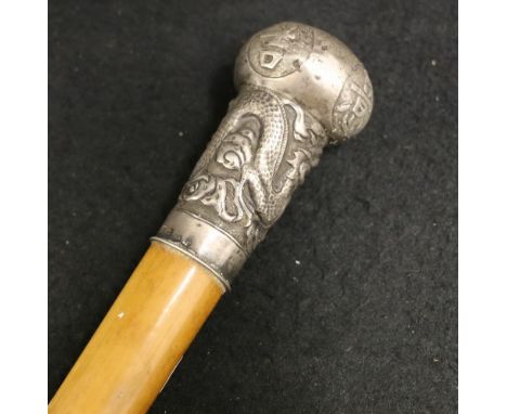 Chinese malacca cane, the silver pommel decorated in relief with a dragon and good luck characters, marked 95, KW (possibly E