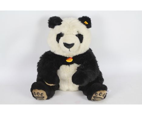 Steiff -  A Steiff #064821 'Manscli' plush Panda Bear approx 36 cms in height, with yellow label and Steiff button to ear wit