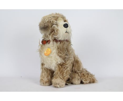 Steiff - A Steiff Skye Terrier 'Treff' #031663. This light brown and cream mohair dog measures approximately 50cms in height 