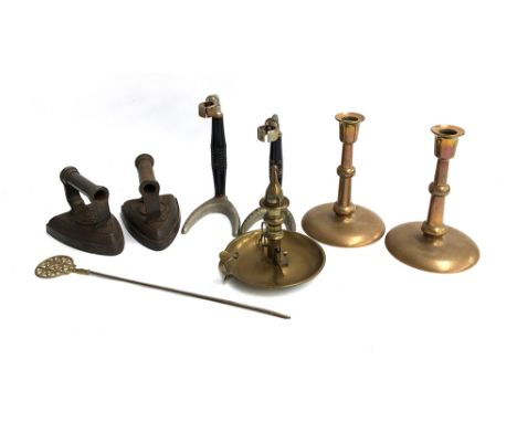 A mixed lot to include pair of irons, each marked 8, 700K; a pair of heavy brass candlesticks, 21cmH; brass candlestick with 