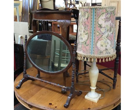 An oval 19th century dressing table mirror on turned supports; together with a resin table lamp with shade 