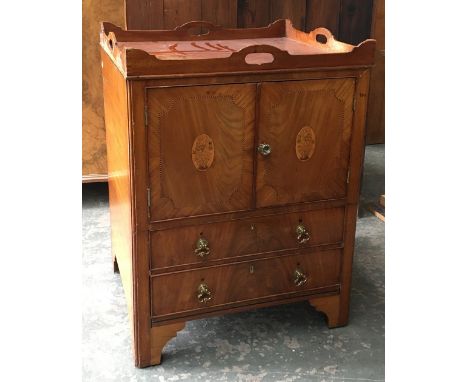 A large Regency commode nightstand, the galleried top with carry handles, over a pair of marquetry and strung doors and two d
