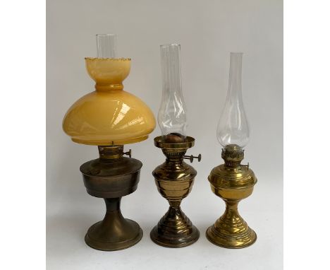An Aladdin 23 brass oil lamp, with chimney and yellow glass shade, 53cmH; together with two others 