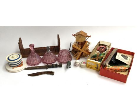A mixed lot to include a set of three pink glass dressing table bottles; wooden windmill (af); carved wood bookslide; boxed P