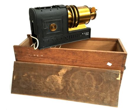 An early 20th century magic lantern projector, later electrical conversion, in wooden case, with sets of pond life samples an