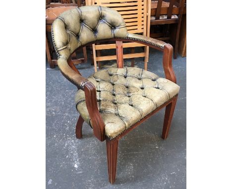 A button upholstered green leather open armchair, on square tapering front legs, 61cmW 