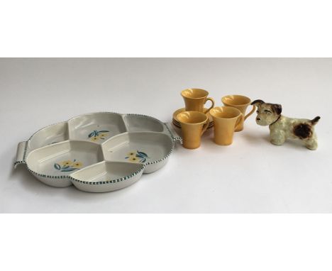 A Poole pottery Hors d'oeuvre dish; together with a set of mid century cups and saucers; together with a dog figurine 