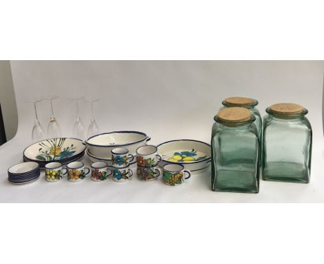 A collection of continental dinner plates, coffee cups, saucers etc, together with Heals glass storage jars 