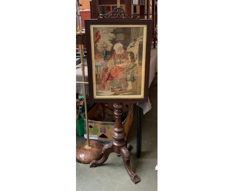A brass pole firescreen, with glazed gros point screen, on a carved tripod base, 151cmH 