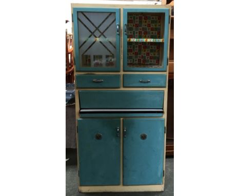 A 1950s kitchen unit, comprising several sets of cupboard doors, drawers and sliding enamel work surface, 83x48x176cmH 