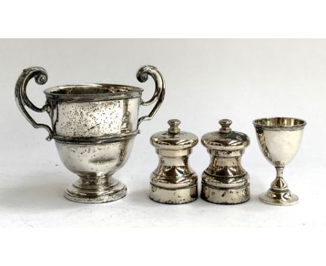 A pair of plated capstan pepper mills with 'Peter Piper' grinders, each 7cm high; together with a plated Eton Fives trophy cu