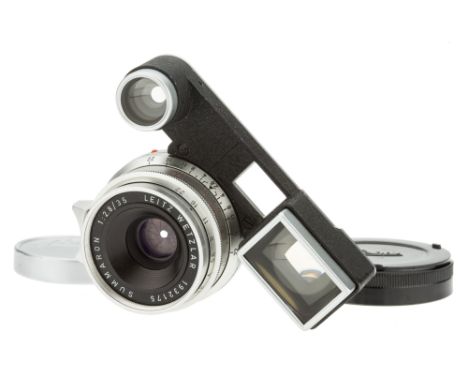 A Leitz Summaron f/2.8 35mm Lens, 1962, with ocular attachment, chrome, serial no. 1932175, body, VG, elements, VG, some ligh