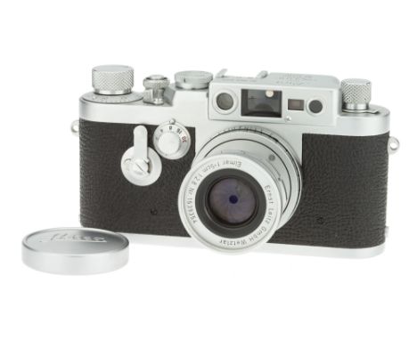 A Leica IIIg Rangefinder Camera, 1957, chrome, serial no. 906942, with Leitz Elmar f/2.8 50mm lens, 1957, chrome, serial no. 