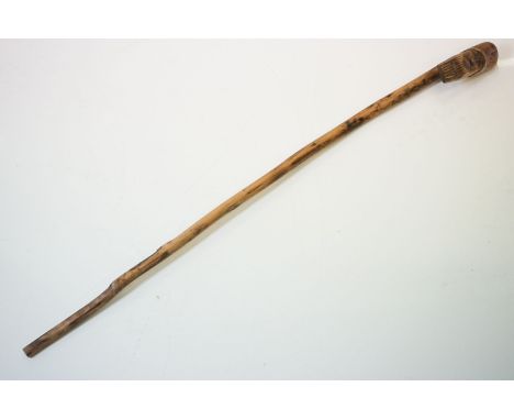 A vintage hand carved walking stick with figural head handle. 