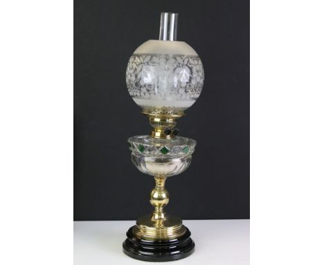 Victorian Oil Lamp with etched glass globular shade, clear and green glass well, brass column and black socle base, 60cm high