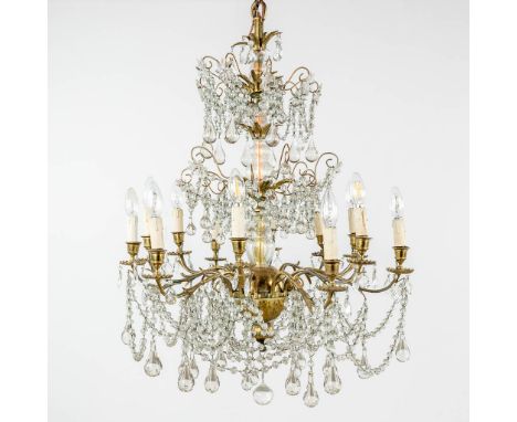 A large chandelier, bronze decorated with glass. 19th century.  (H: 90 x D: 70 cm)