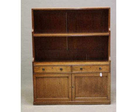 A REGENCY MAHOGANY BOOKCASE, early 19th century, the reeded edged back with single fixed shelf, two frieze drawers with brass