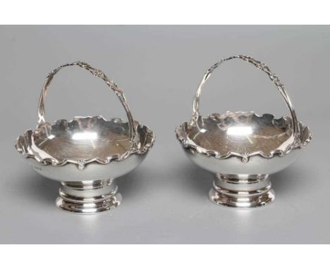 A PAIR OF SILVER EPERGNE BASKETS, maker C Boyton &amp; Sons, London 1920, of flared circular form with fixed over head scroll