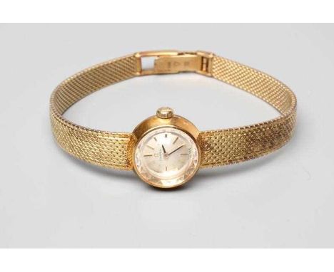 A LADY'S 14CT GOLD OMEGA WRISTWATCH, the silvered dial with gilt metal batons in a plain tapering case on integral woven brac