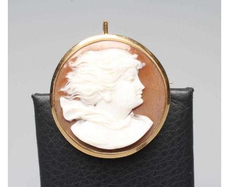AN ITALIAN SHELL CAMEO, the circular panel cut with the head portrait of a young lady with flowing locks, the plain brooch/pe