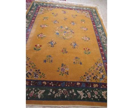 A CHINESE CARPET, early 20th century, the gold field with scattered floral sprays, floral central medallion and conforming sp