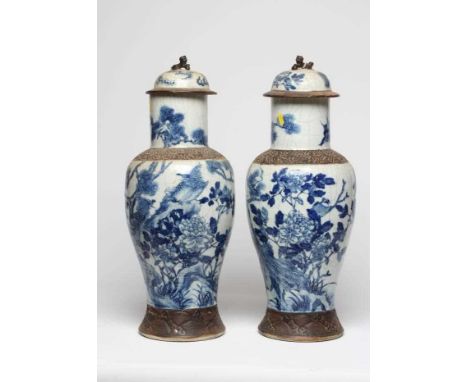 A PAIR OF CHINESE CRACKLE GLAZE VASES AND COVERS of inverted baluster form painted in underglaze blue with flowering shrubs a