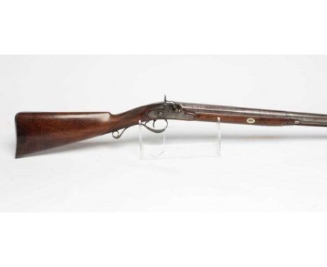 A PERCUSSION SHOTGUN by Seager, late 19th century, the 32" damascus barrel octagonal at the breech, waterproof pan, foliate e