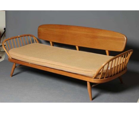 AN ERCOL MODEL 355 STUDIO COUCH, in blond beech and elm with loose cushions in a pale green and salmon linen check, 80 1/2" x