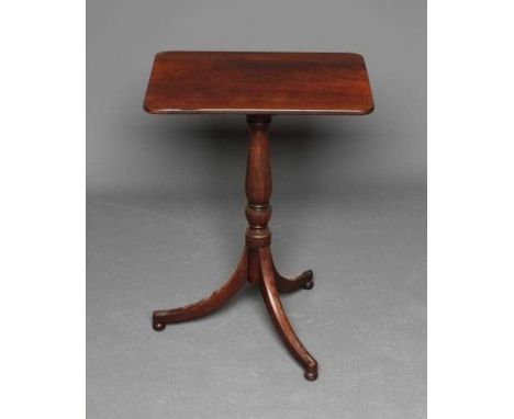 A REGENCY MAHOGANY WINE TABLE, early 19th century, the rounded oblong top on turned vase stem, on tripod base with sabre legs