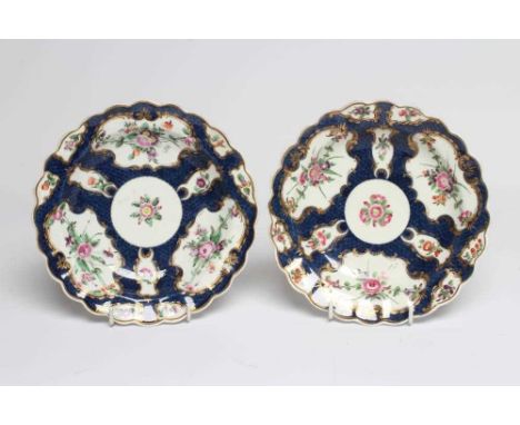 A PAIR OF FIRST PERIOD WORCESTER PORCELAIN PLATES, c.1770, of circular form with fluted rims, painted in polychrome enamels w